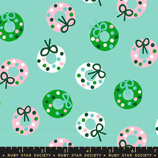 Pattern of colorful wreaths and bows on a teal background with a ruler at the bottom.