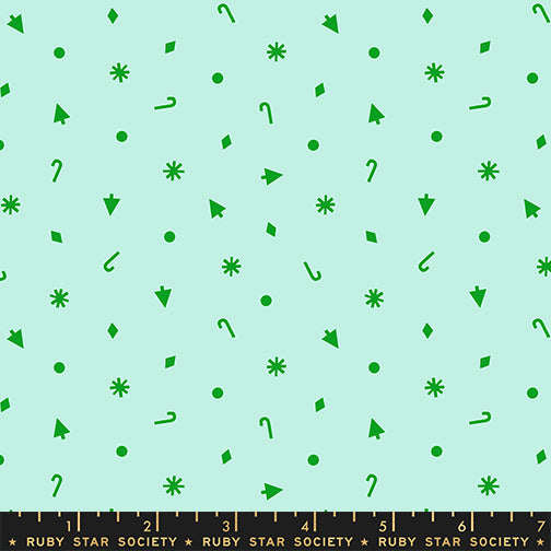 Green geometric pattern on a light green background with a ruler at the bottom.